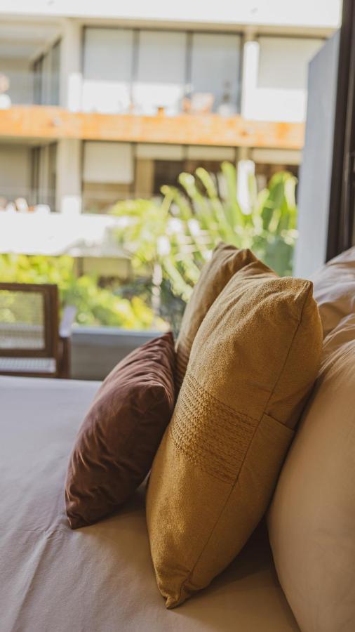 Xperience Tulum Hotel Exterior photo Throw pillows on a sofa