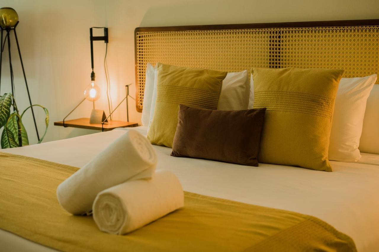 Xperience Tulum Hotel Exterior photo A bed with pillows and a lamp